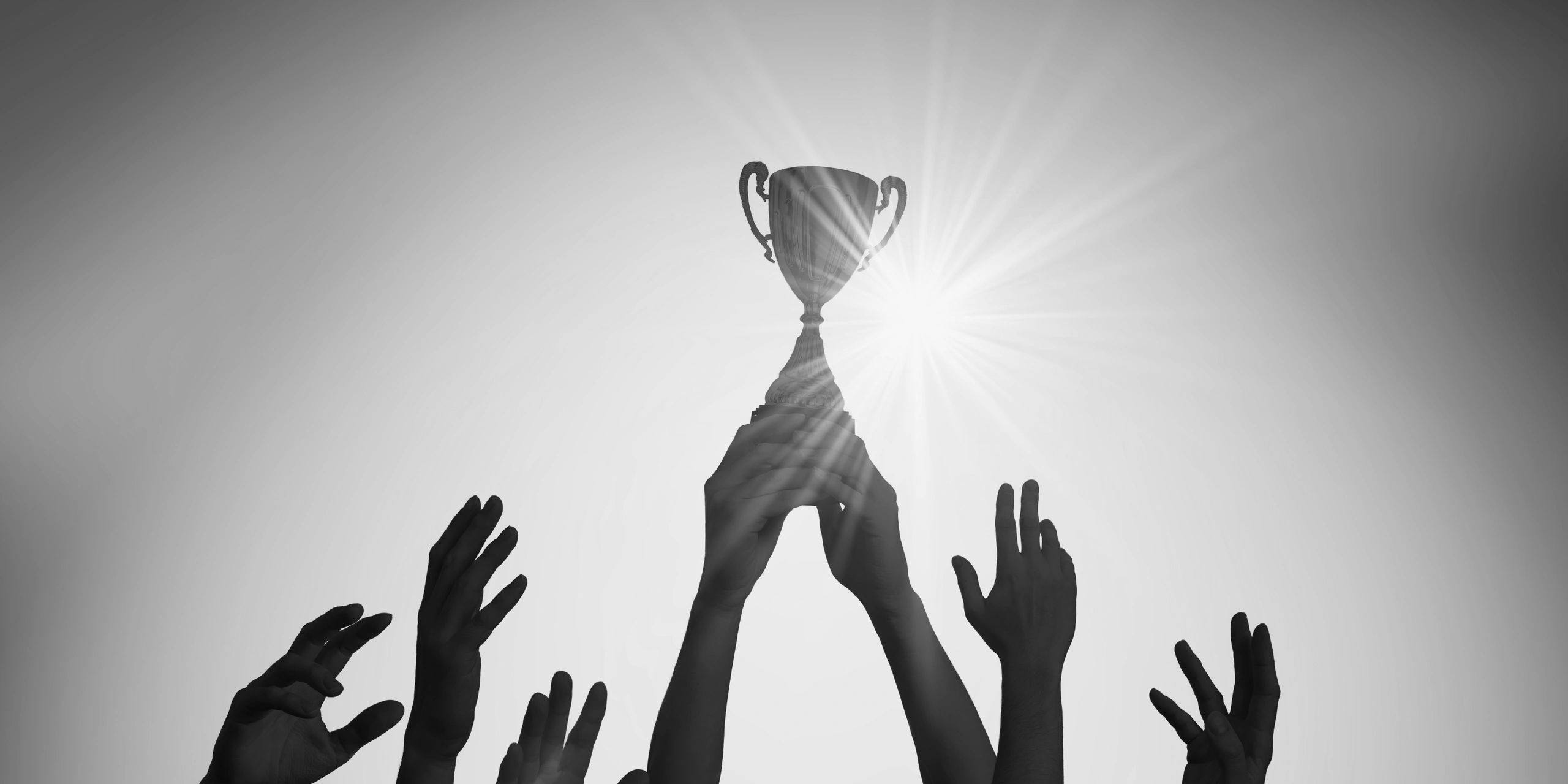 Image of hands holding up a trophy