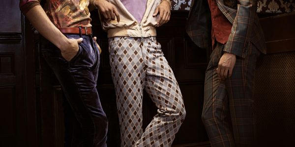 Three men wearing vintage patterned pants and jackets.