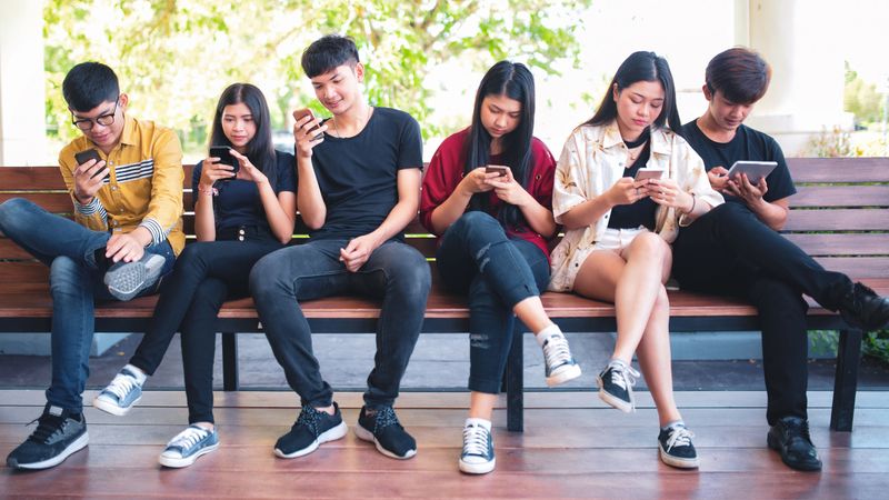 Group adult hipsters friends sitting sofa using hands modern smartphone tablet, Business startup friendship teamwork concept, People working together project