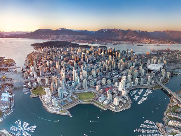 Aerial view of a coastal city surrounded by mountains.