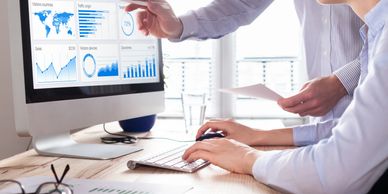 Two professionals analyzing website analytics on a desktop computer.