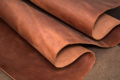 Rolled brown leather sheets.