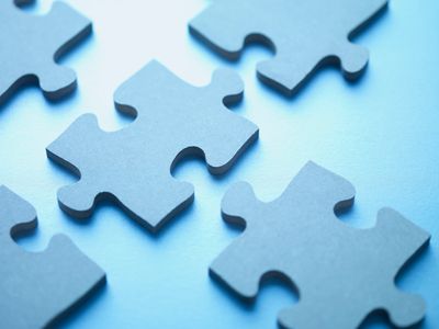 Blue puzzle pieces representing different parts of self explored in Internal Family Systems (IFS)