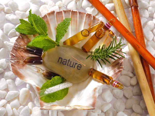 Natural healing elements arranged in a shell with the word 'nature'.