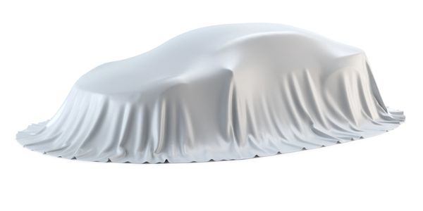A car covered with a white cloth, concealing its shape.