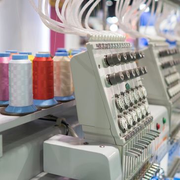 Industrial embroidery machine with colorful threads.