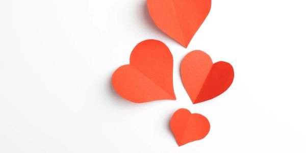 Red paper hearts on white background.