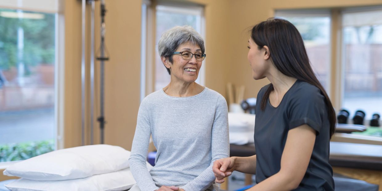 Two women having a friendly conversation indoors.