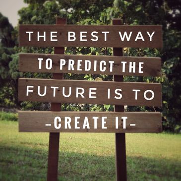 Wooden signboard with an inspirational quote in a green outdoor setting.