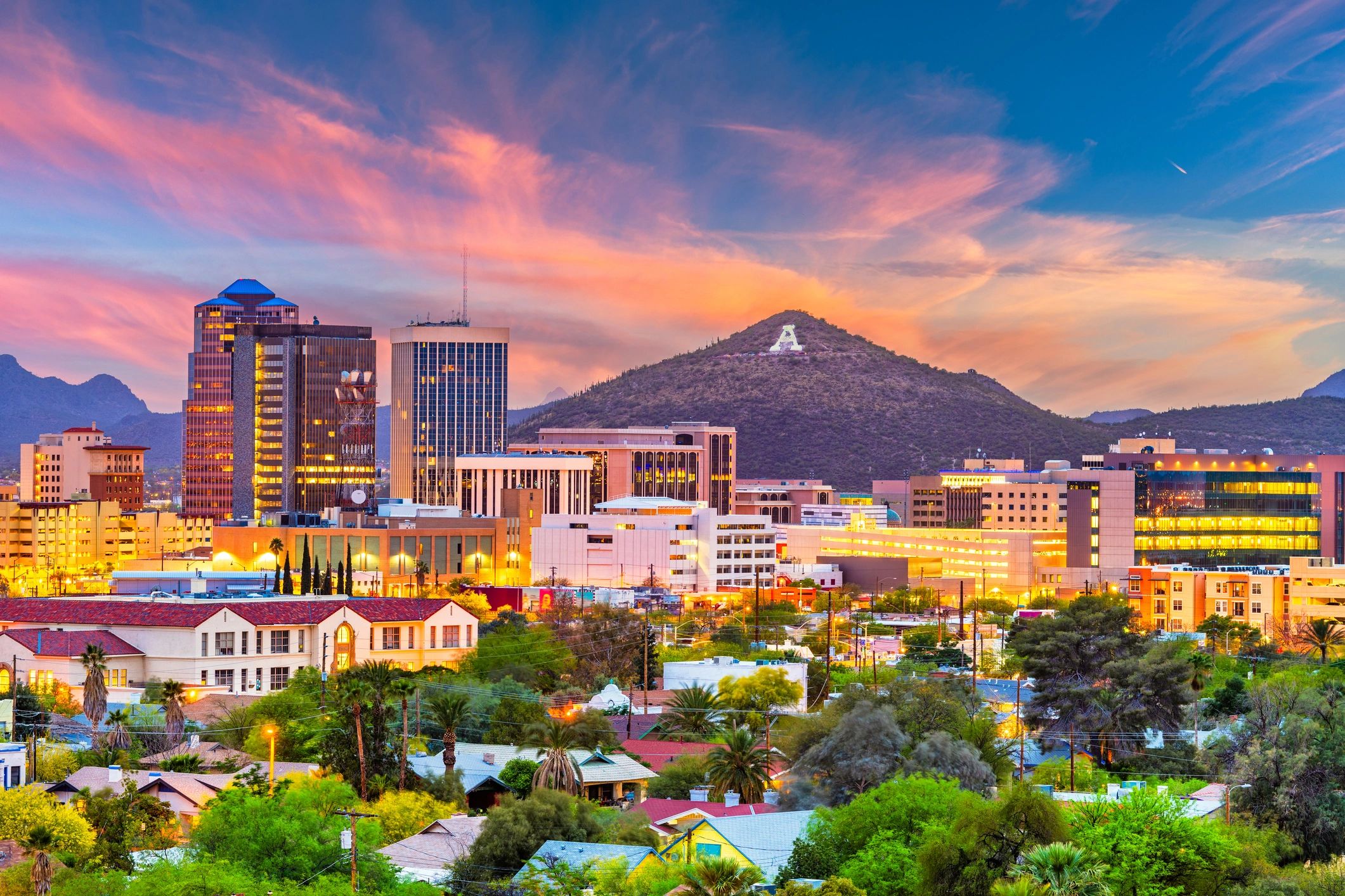 Sunset over Tucson cityscape with Mount Lemmon and the iconic 'A' on Sentinel Peak.