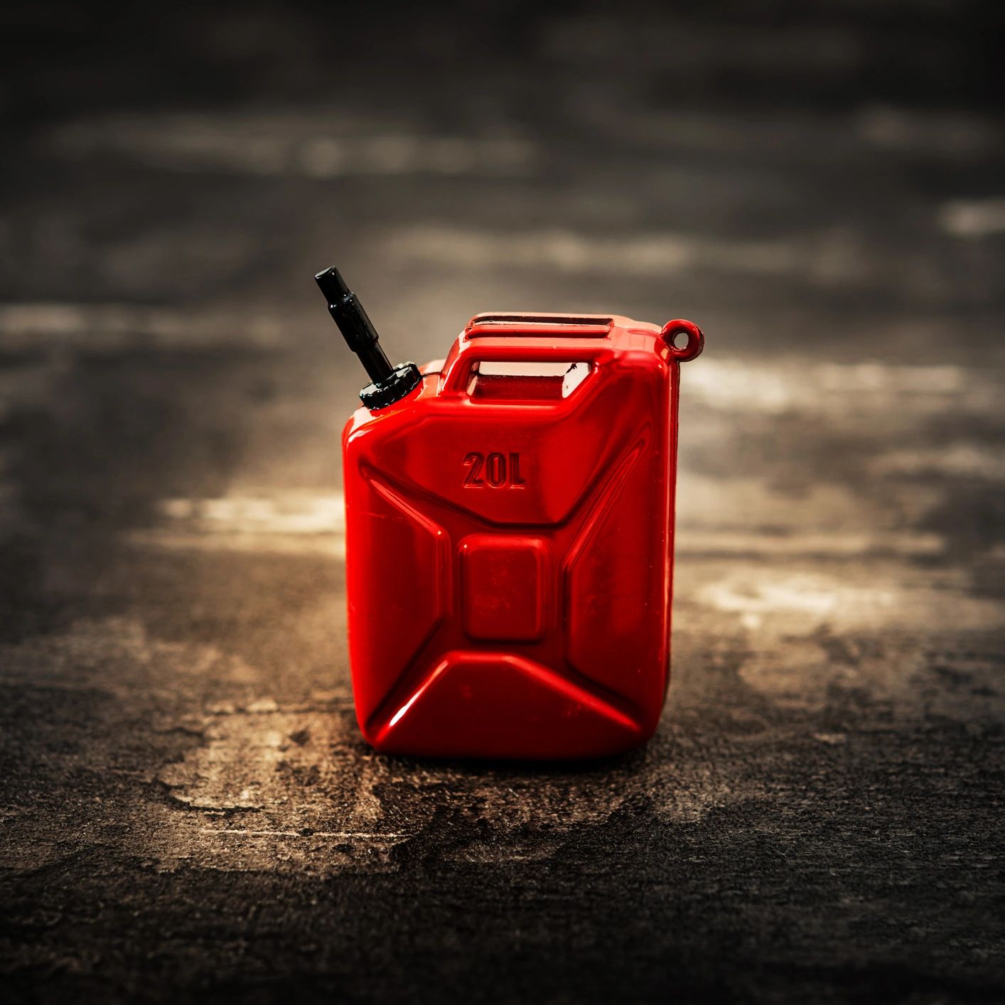 Red 20-liter fuel container on a textured surface.