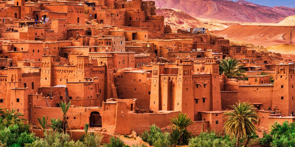 Ancient earthen buildings in a desert valley.
