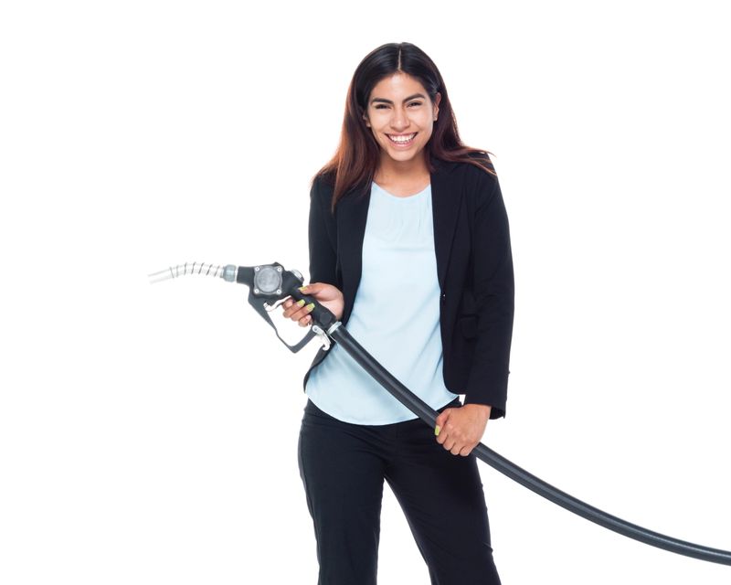 Businesswoman pumping petrol