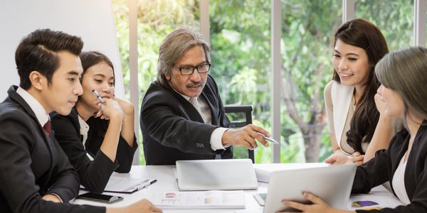 Person using tablet with overlaid financial charts and business data visuals.
