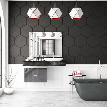 Modern bathroom with hexagonal wall tiles and geometric lights.