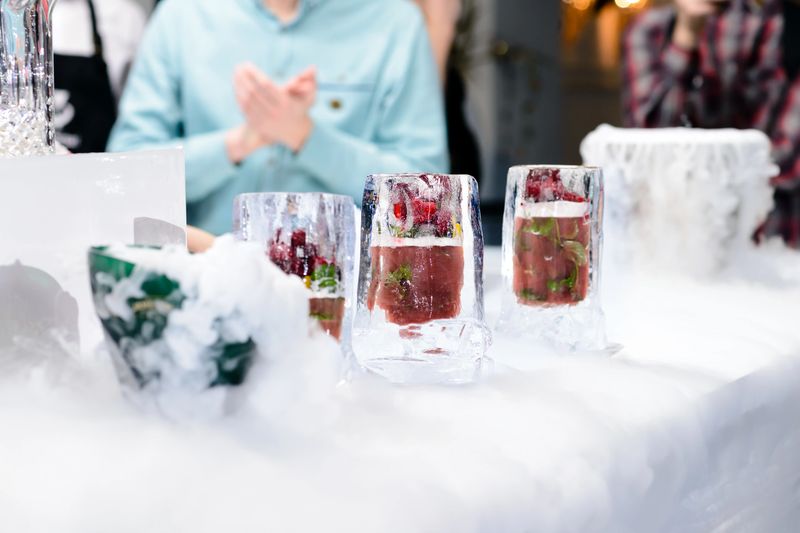 Berries alcohol cocktail in an ice glasses on the bar counter, shallow dof