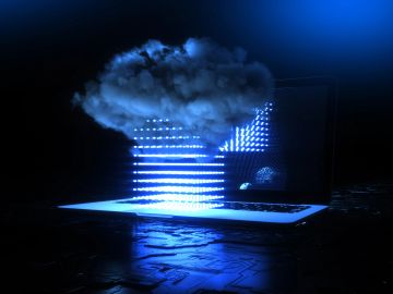 A cloud hovers above a glowing laptop, symbolizing cloud computing.