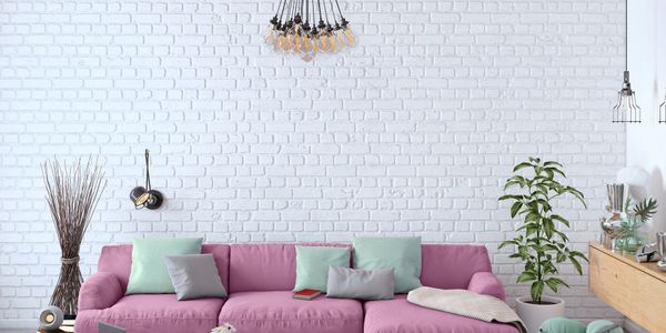 Modern living room with a purple sofa and white brick wall.