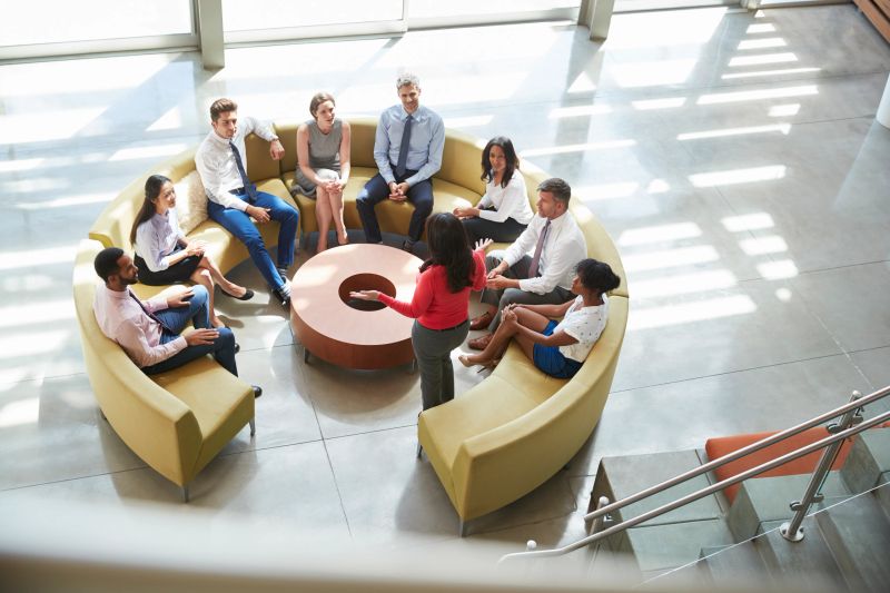 Businesswoman presenting at team meeting, elevated view