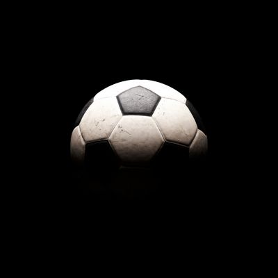 A classic black and white soccer ball against a dark background.