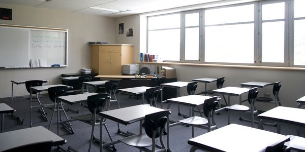 Empty classroom with desks and chairs.