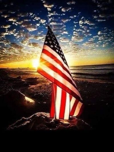 A American Flag Flying in Sunrise With Clouds