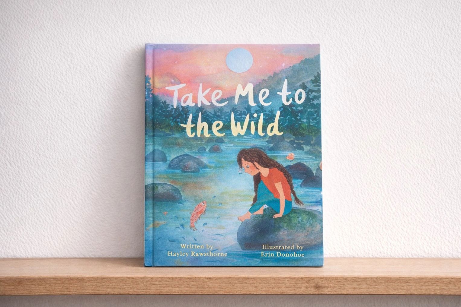 Children's book titled "Take Me to the Wild" with colorful nature illustration.