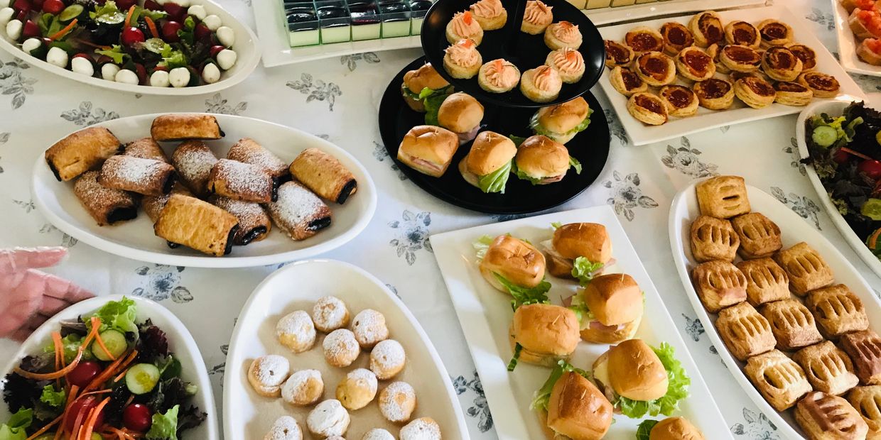 A variety of appetizers and pastries arranged on a table for a party.