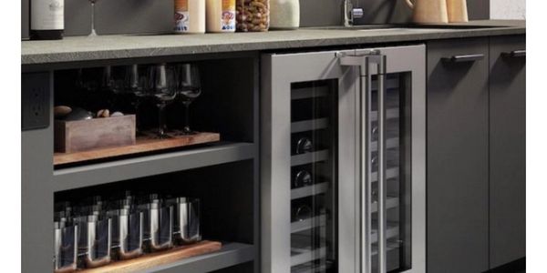 Modern kitchen cabinetry with built-in wine cooler and glassware storage.