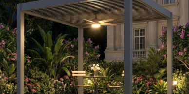 Outdoor seating area under a pergola with lush greenery.