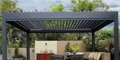 Modern outdoor pergola with seating and dining area.