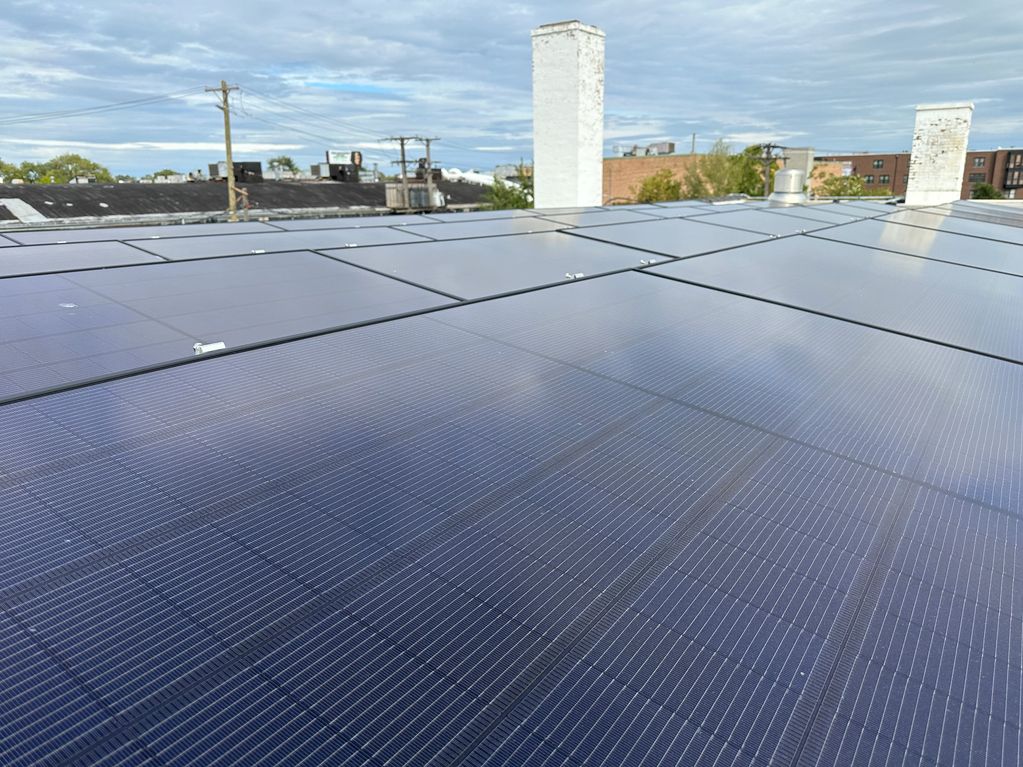 Solar panels installed in front of the old Coal fired boiler chimneys