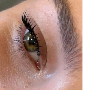 a close up picture of a womans eye after a lash lift and tint