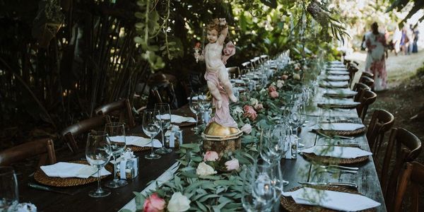 Elegant outdoor dining table with floral decorations and glassware.