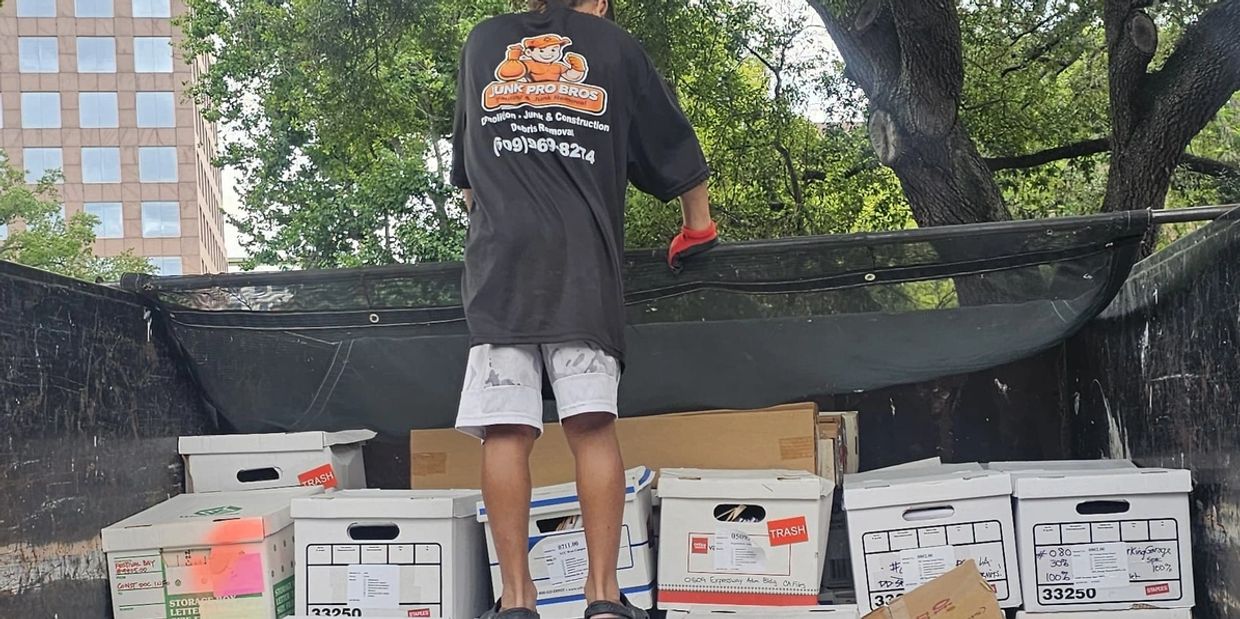 Boxes of business documents prepared for secure shredding and paper recycling by Jun Pro Bros in Central Florida