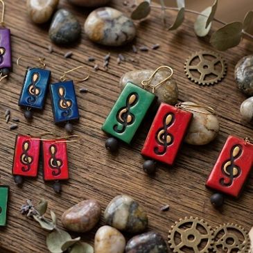 Handmade earrings with musical note designs.