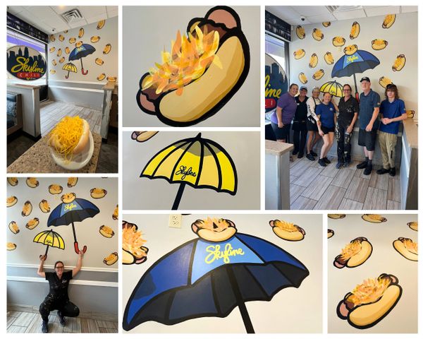 Skyline Chili restaurant with signature umbrella and hot dog murals, staff, and cheese-covered chili dish.