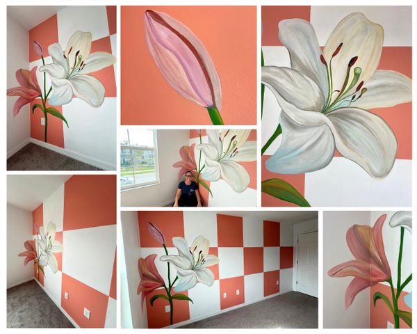 A vibrant floral mural with white lilies on an orange and white checkerboard wall.