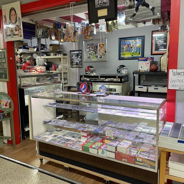 Authentic Upper Deck sports jerseys and trading cards in display cases.