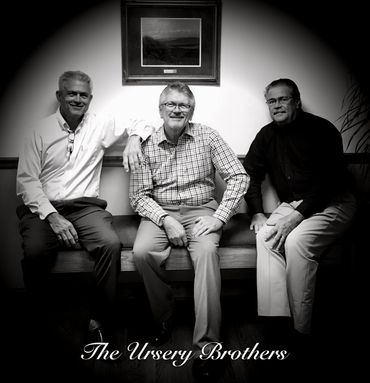 Three men sitting on a bench titled The Ursery Brothers.