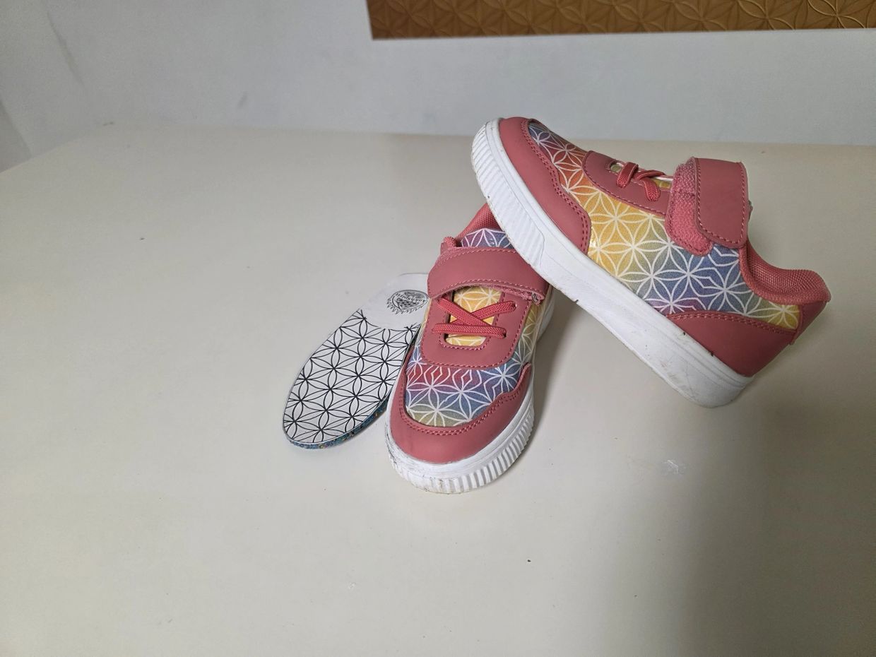 Colorful children's sneakers with geometric patterns and a separate insole.