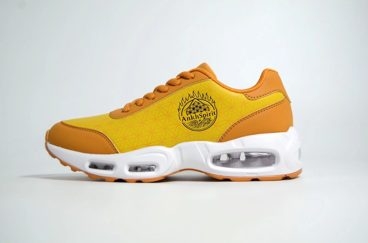 Yellow and orange sneaker with visible air cushioning and AnkhSpirit logo.