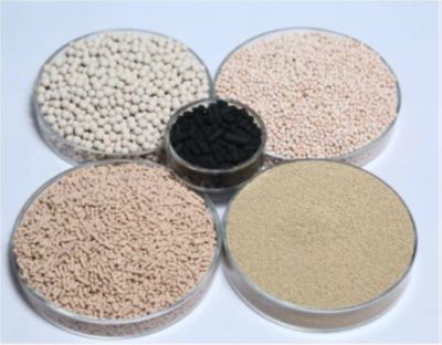 Various types of granular and pelletized materials in clear round containers.