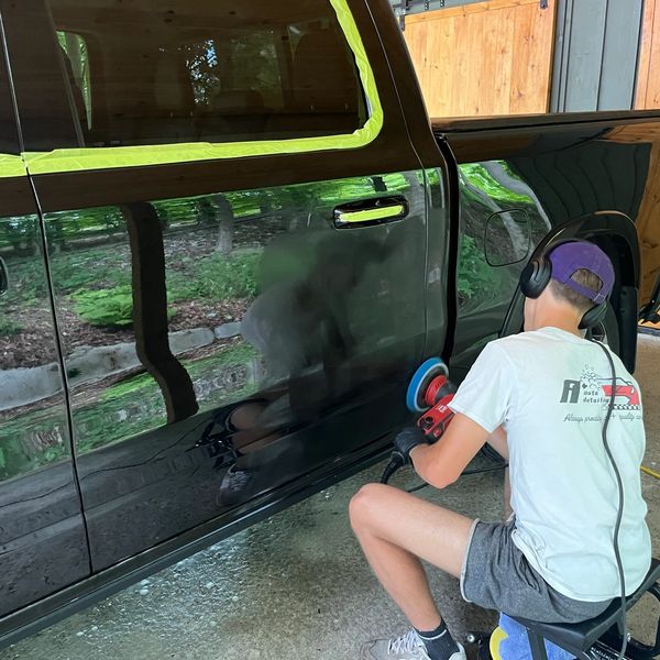 Mobile auto detailer polishing the paint on a truck 