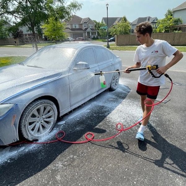 Prepping the BMW with pre-foam before contact wash