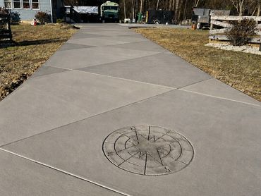 Concrete driveway with compass design.