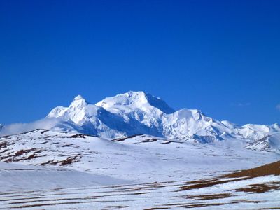 Snow-covered mountain peaks under a clear blue sky.