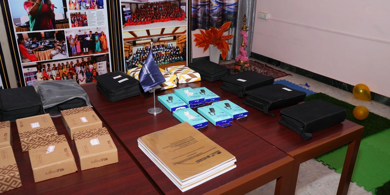 Organized conference materials and awards displayed on tables.