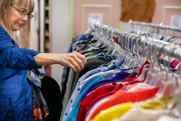 Woman checking the dress on the rack 