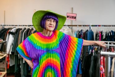 woman posing for a picture in rainbow themed dress